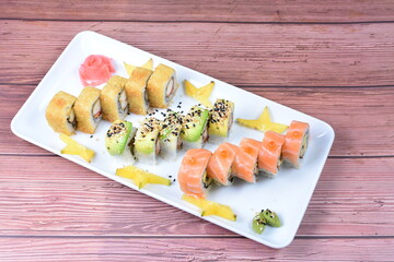 Traditional colorful suhi, cream cheese, salmon, caviar, rool sishi crunch, sesame seeds and sauce