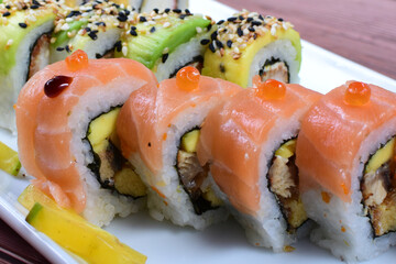 Traditional colorful suhi, cream cheese, salmon, caviar, rool sishi crunch, sesame seeds and sauce
