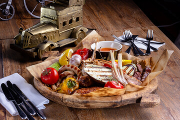 Grill. Lamb ribs, sausages, vegetables, eggplants, tomatoes are in a large plate