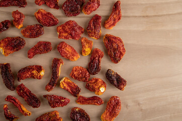Slices of sun-dried tomatoes on wooden background	