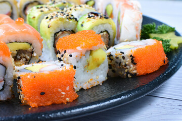 Traditional colorful suhi, cream cheese, salmon, caviar, rool sishi crunch, sesame seeds and sauce