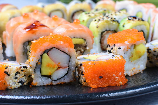 Traditional colorful suhi, cream cheese, salmon, caviar, rool sishi crunch, sesame seeds and sauce