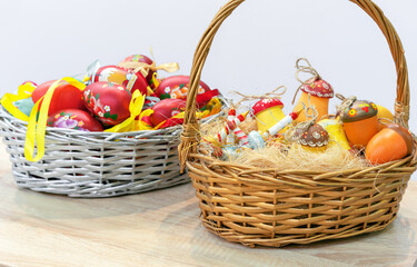 Wooden Easter eggs with floral ornaments in a wicker basket.