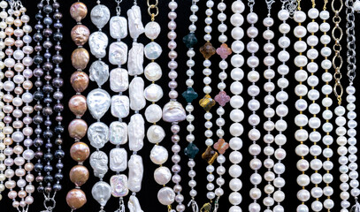 White pearl and mother-of-pearl bracelets in a jewelry store window.