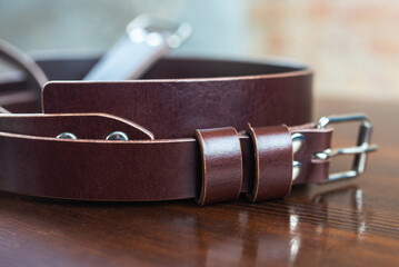 Stylish leather belt on wooden background for mens