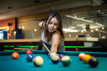 pretty lady take to easy shoot to win in billiards game