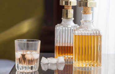Luxury glass bottles with different alcoholic spirits inside, copy space photo