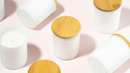 Handmade candles made of eco- and vegan soy wax on a light rose background. Soy candle with a...