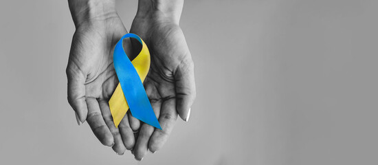 Hands hold Ukraine flag. Pray for Ukraine. Protest against the Russian intervention to Ukraine,...
