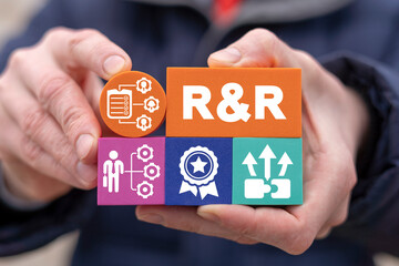 Concept of roles and responsibilities. Businessman holding colorful styrofoam blocks with R and R abbreviation and other social business icons. Employee role and responsibility.