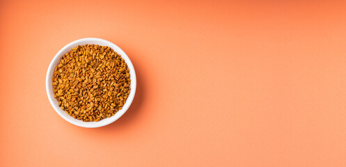 Fenugreek seeds in the ceramic bowl - Healthy food