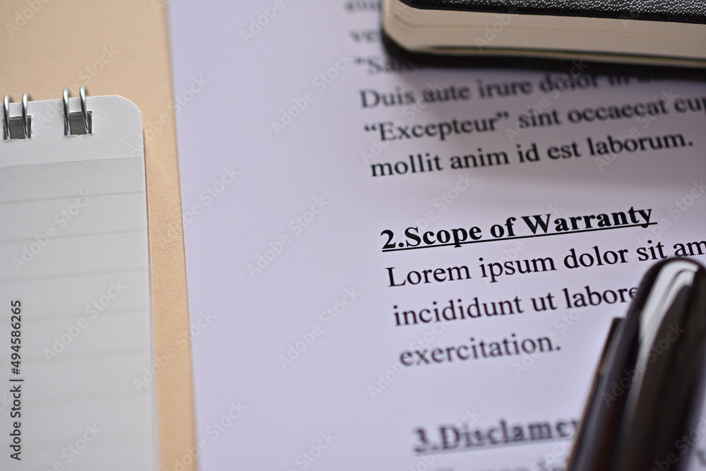 Aufkleber close up of the part of document, scope of warranty is placed there along with a pen and a notebook
