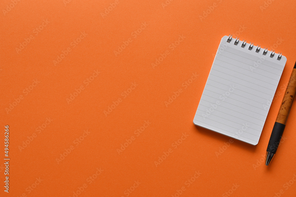 Poster a notebook and pen in a simple composition. copy space available.