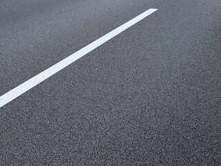 The lane marking on a German autobahn appears as an abstract graphic in the close-up. 