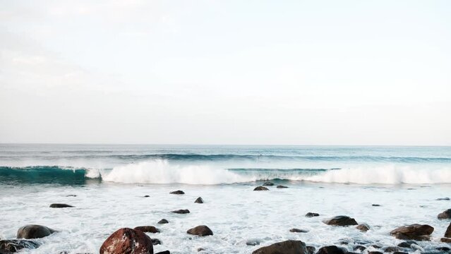 Serfers on a ocean wave on sunset, Atlantic Ocean