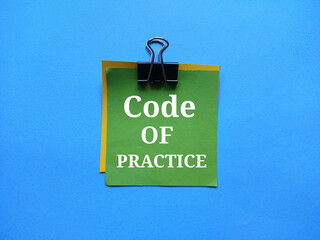 Paper clips along with colored paper with the concept of the word Code Of Practice.