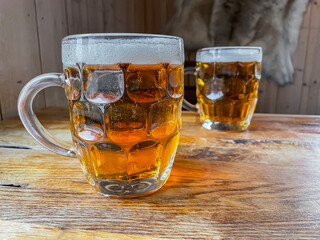 Delicious beers in glass jars on a wooden table