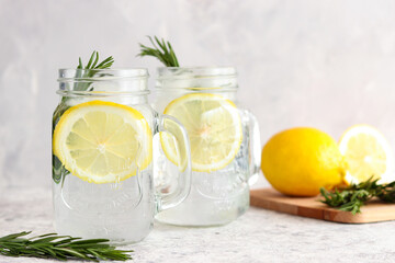 Homemade lemonade with ice, lemon and rosemary. Refreshing summer drinks. Detox concept. Close-up, selective focus