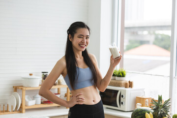 young Asian woman person cooking in kitchen with a healthy food concept, drink and organic vegetable