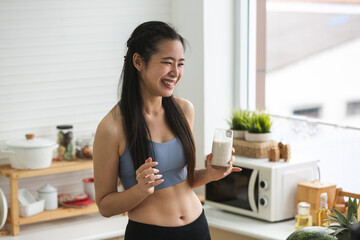 young Asian woman person cooking in kitchen with a healthy food concept, drink and organic vegetable