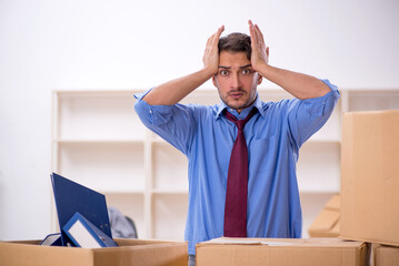 Young male employee in office relocation concept