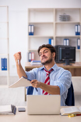 Young male employee working in the office