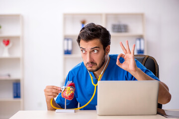 Young male doctor cardiologist working in the clinic