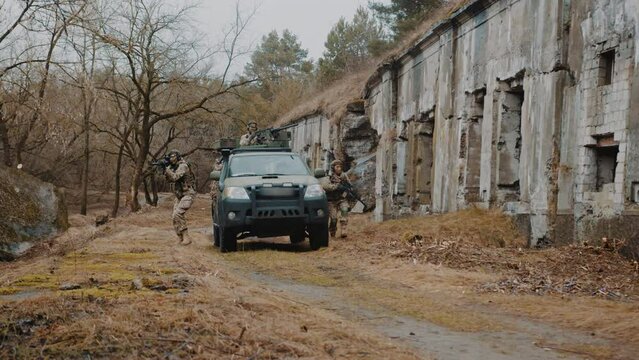 Army marine squad taking over civilian territory with grit debris. High quality 4k footage