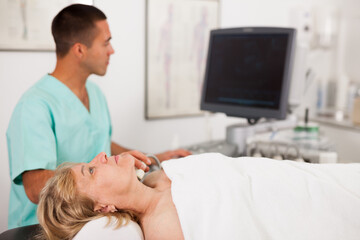 Obraz na płótnie Canvas Mature woman getting ultrasound scanning examination at clinic