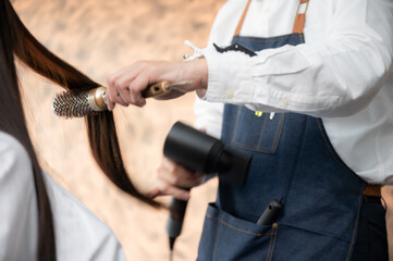Naklejka premium woman client person having a process to making treatment a hair with hairdresser in beauty salon