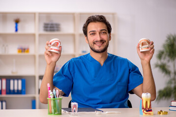 Young male dentist working in the clinic