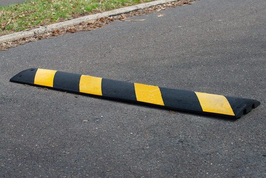 Black and yellow bright speed bumps on the road