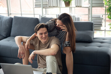 young couple are happy and fun to working business job at home by using online device communication