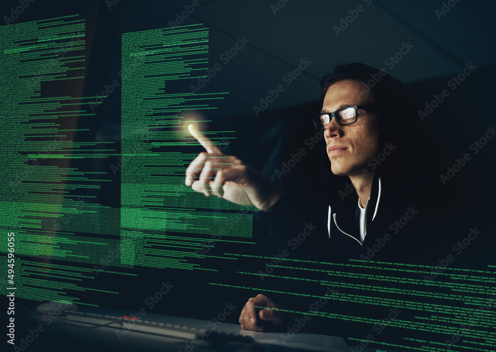 Poster hacking your system one touch at a time. cropped shot of a young hacker cracking a computer code in 