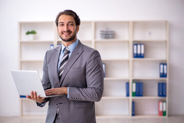 Young male employee working in the office