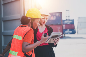 Team worker American women Work in an international shipping yard area Export and import delivery service with containers