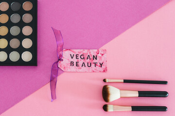 cruelty free beauty products, Vegan Beauty label next to make-up brushes and eyeshadow palette
