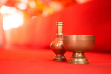 Selective focus of pour water brass on the red carpet at temple in Thailand  and copy space