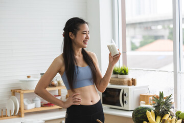 young Asian woman person cooking in kitchen with a healthy food concept, drink and organic vegetable