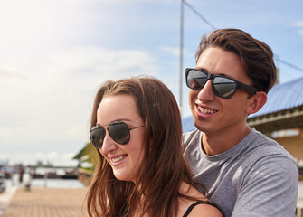 Enjoying a day in paradise. Shot of an affectionate young couple standing together outside.