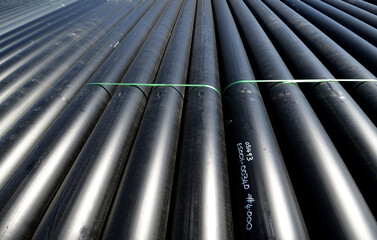 large pipes in storage area on site.