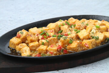 Freshly cooked Filipino food called Sizzling Tokwa Sisig or chopped tofu served in a hot plate