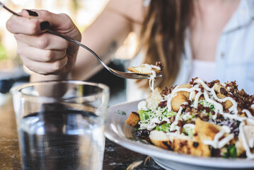 Woman eating Cesar salad