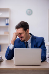 Young male employee working in the office