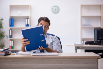 Young male employee working in the office