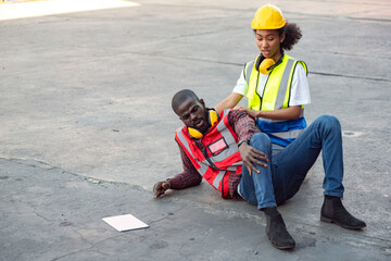 African-American male and female engineers injured the accident from working to load containers at...