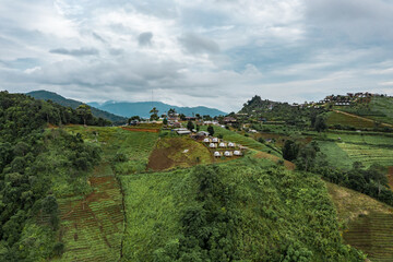 Fototapeta na wymiar An aerial photographic view of Mon Jam Village in Chiangmai, filled with houses, resorts, and homestays for all the visitors.