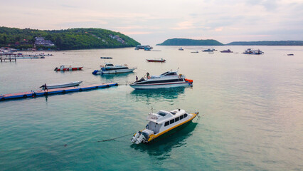 Fototapeta premium aerial view of ships inNusa Penida island pier at dusk