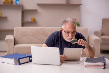 Old male employee working from home during pandemic