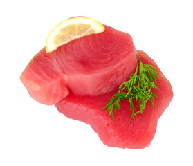 Two fresh raw yellow fin tuna fish meat steaks with lemon and dill herb garnish